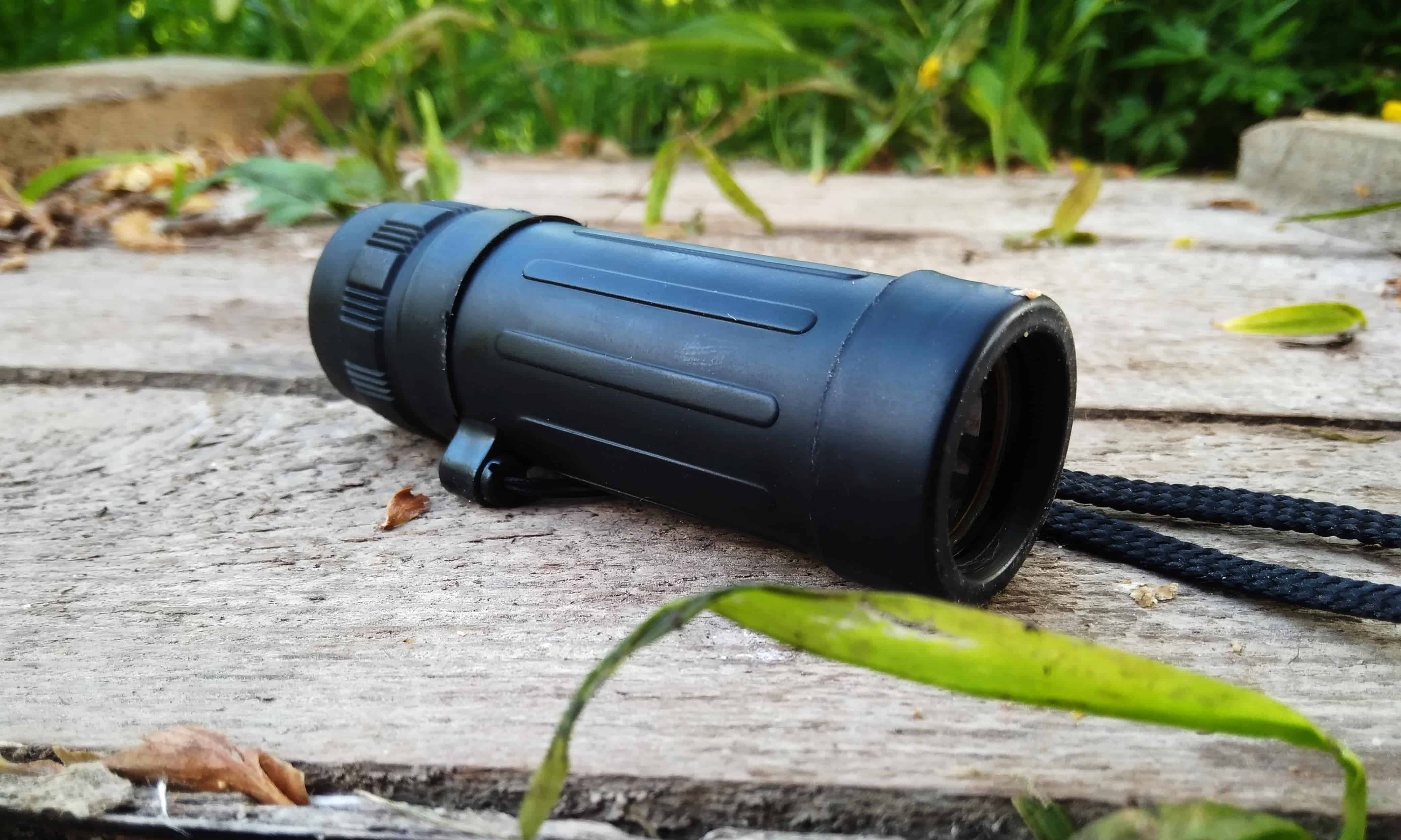 Monocular outdoors on wooden table