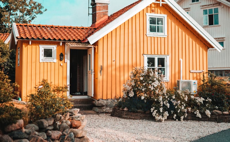 Orange house with small gravel driveway