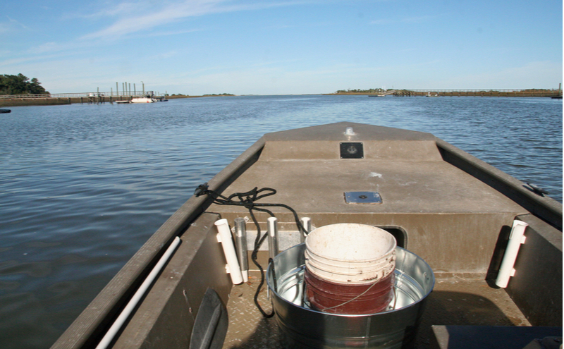 Driving jon boat over water.