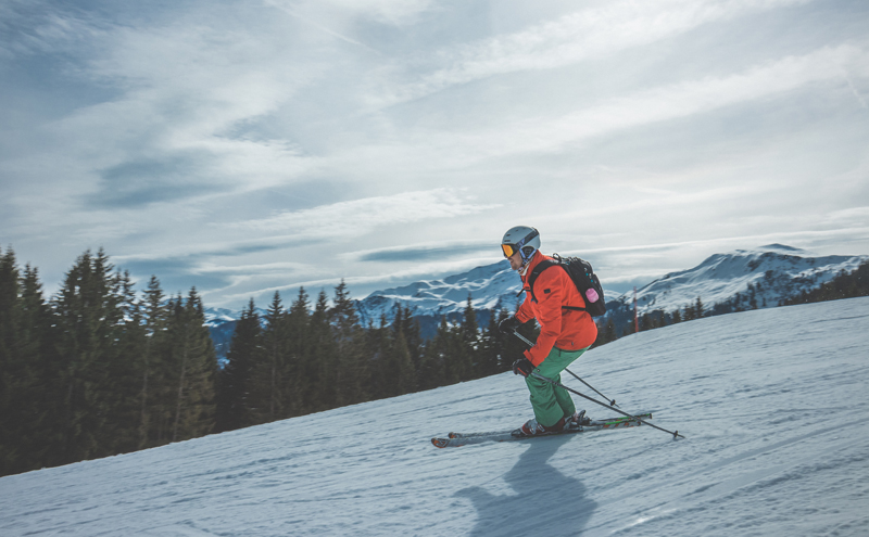 Man skiing on snow in the mountains.