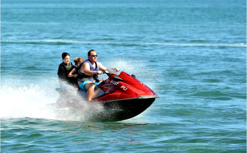Visiting tourists enjoy a jet ski ride in the waters off of Key West, Florida