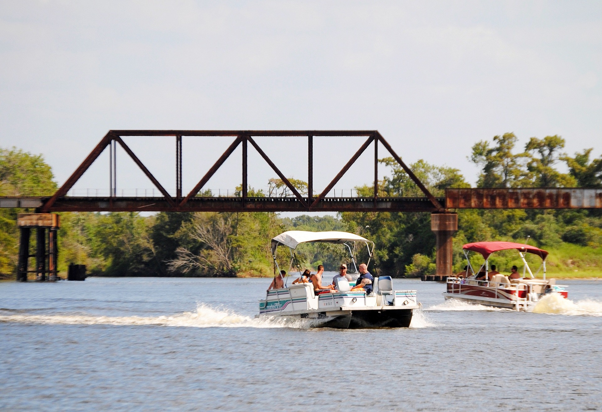 Two pontoon boats on a lake.