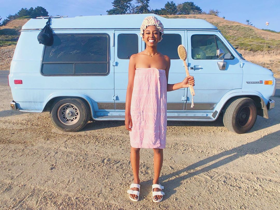 Jannelle Eliana in front of her blue van.