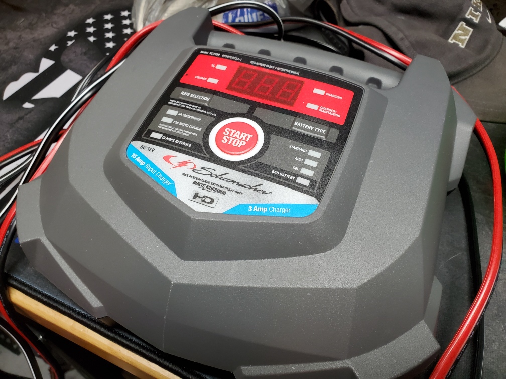 Battery charger on garage workbench.